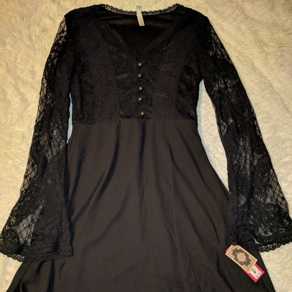 Cute black dress with lacey bell sleeves.